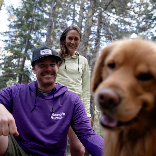 Male and female models wearing the Mountain Gazette x Burgeon Outdoor Hooded Sweatshirt outside