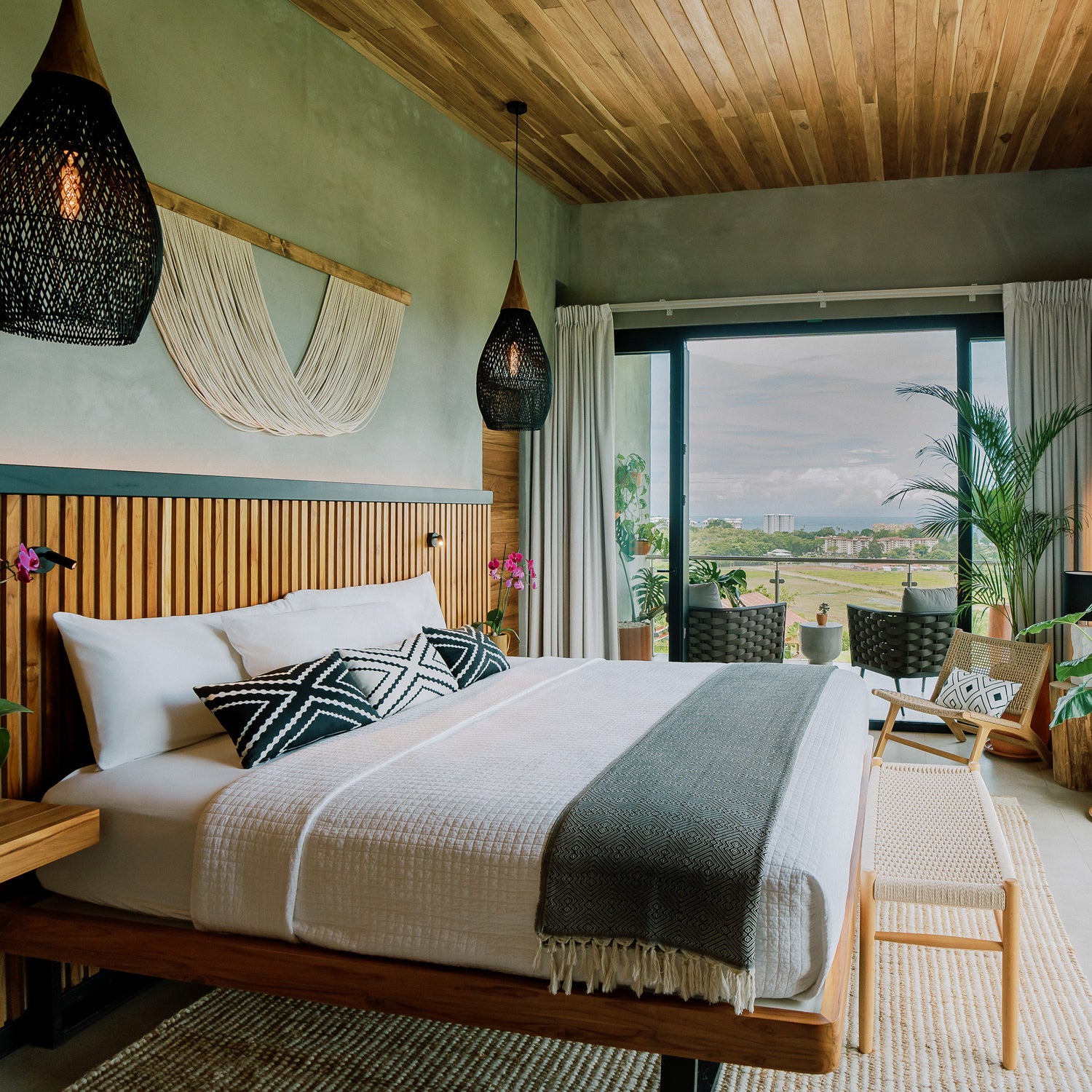 Modern bedroom with wooden bed, large windows, and outdoor view