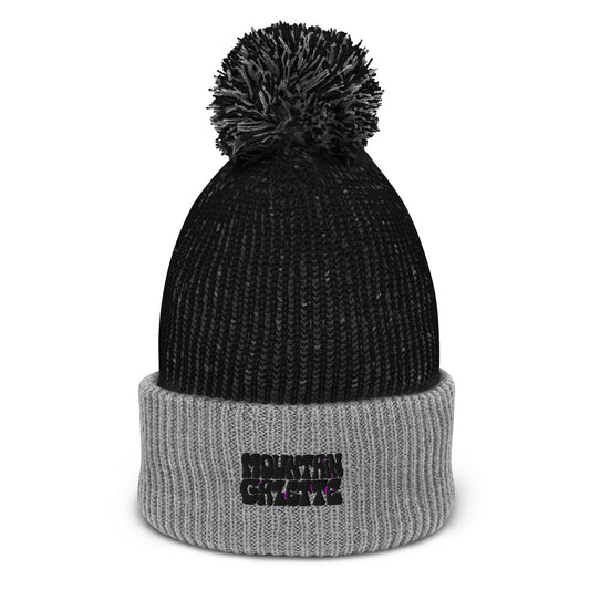 Warm and stylish pom-pom beanie with mountain-themed logo