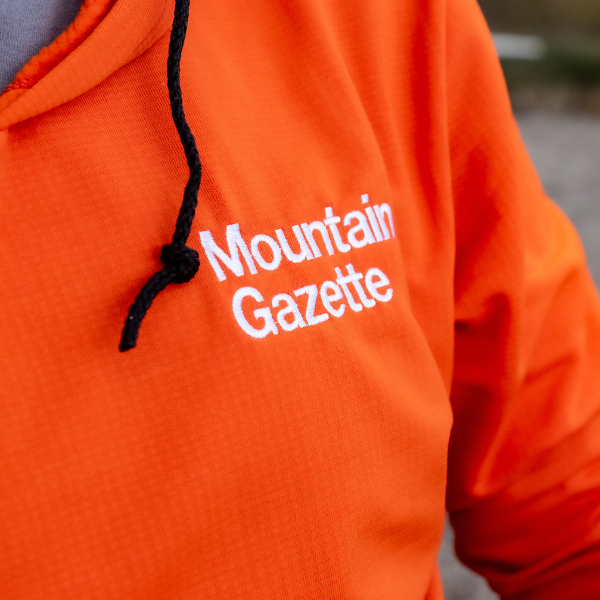 Detail of the Mountain Gazette x Burgeon Outdoor Hooded Sweatshirt in  Orange