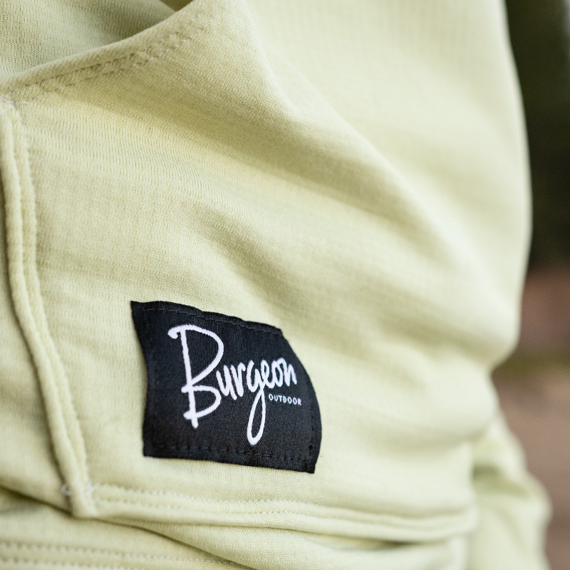 Detail of the Burgeon Outdoor logo patch on the Mountain Gazette x Burgeon Outdoor Hooded Sweatshirt in Light Green