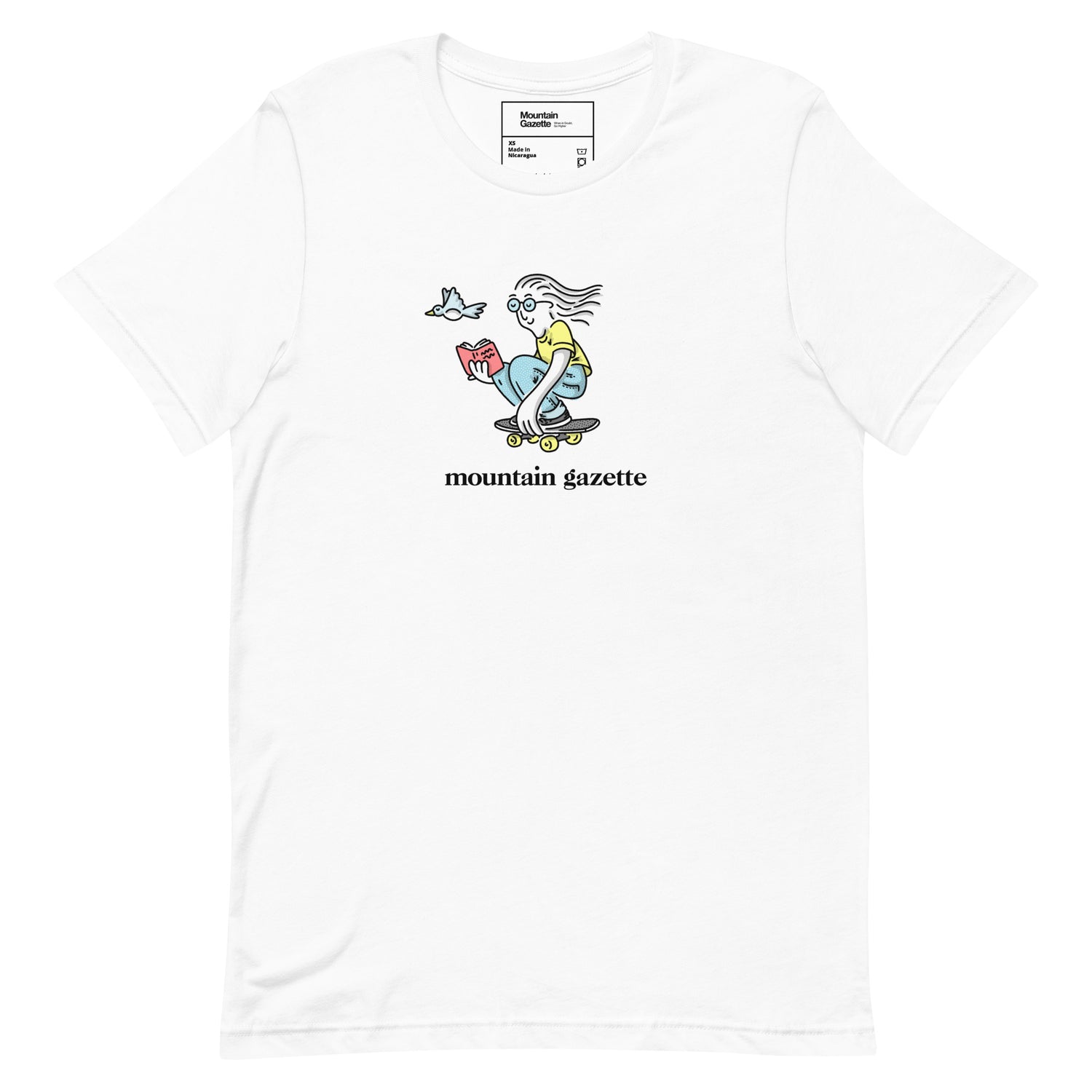 White t-shirt with a graphic design of a skateboarder reading a book and 'mountain gazette' text on a white background