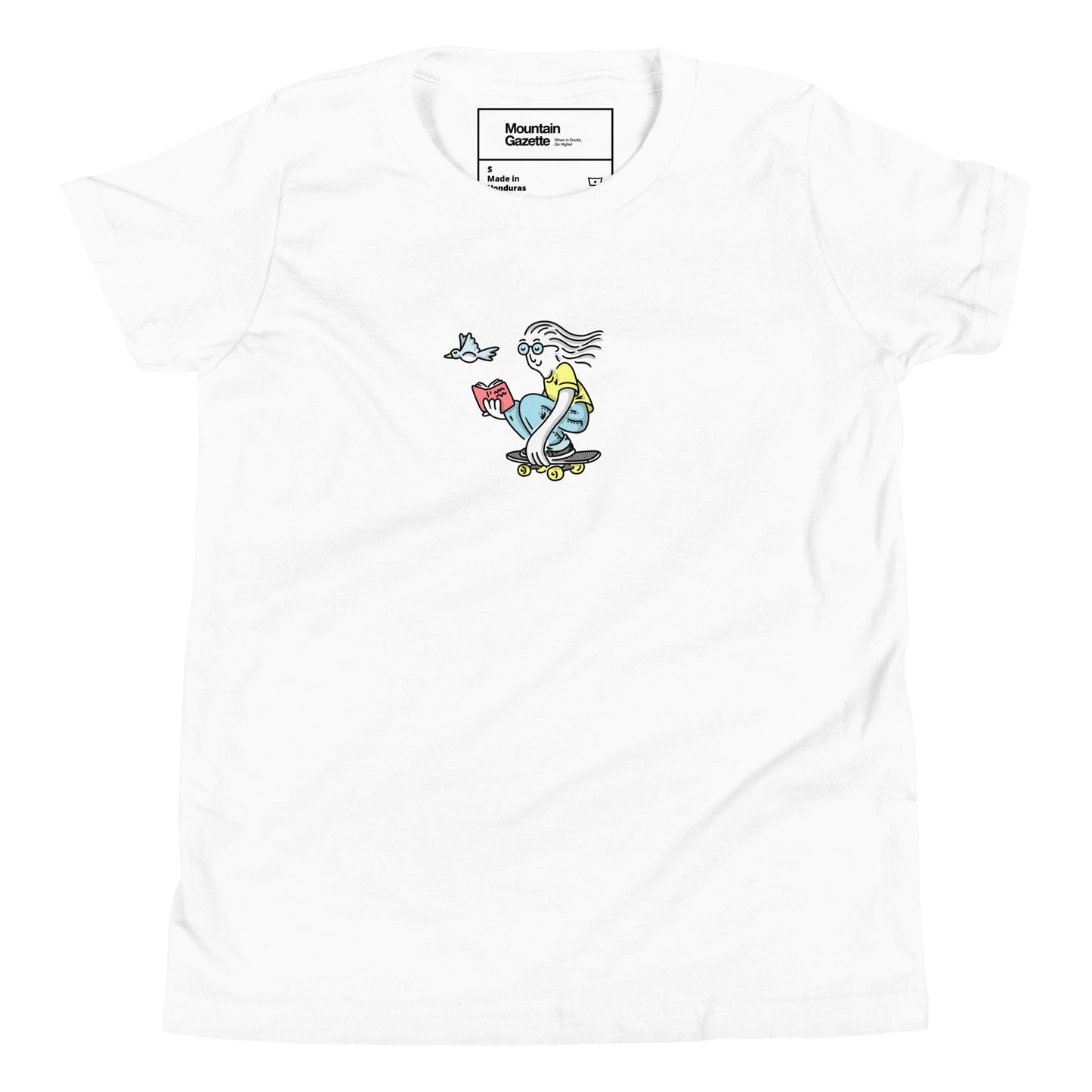 White t-shirt with a colorful graphic of a skateboarder reading a book, on a white background.