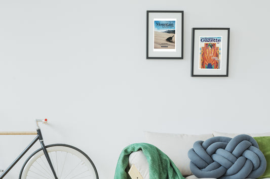 Issue 106 vintage Mountain Gazette magazine cover art shown framed on a wall